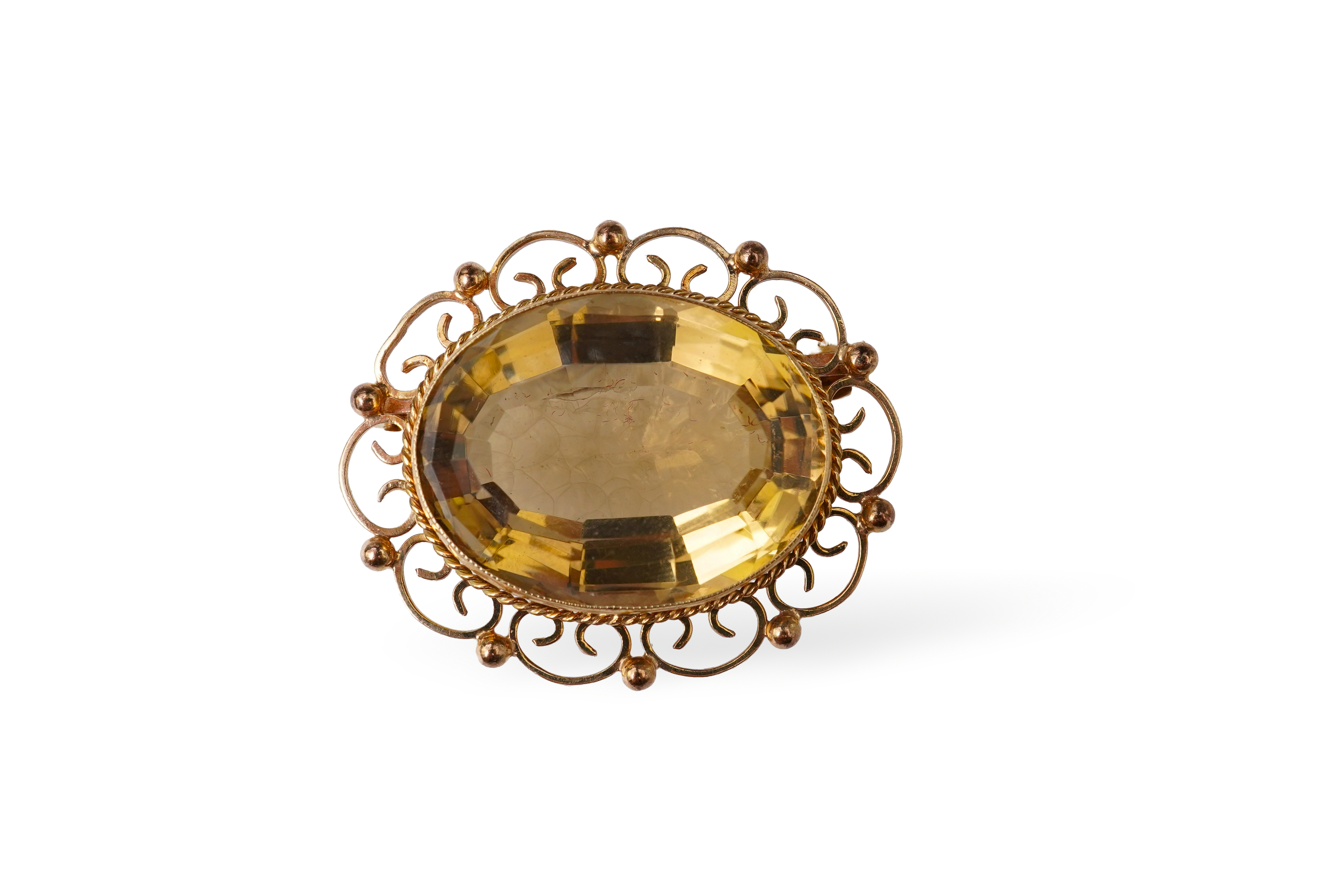 A 9ct gold and citrine brooch, set with an oval citrine within an openwork border, length 3.7cm, British hallmarks, gross weight approximately 13 grams